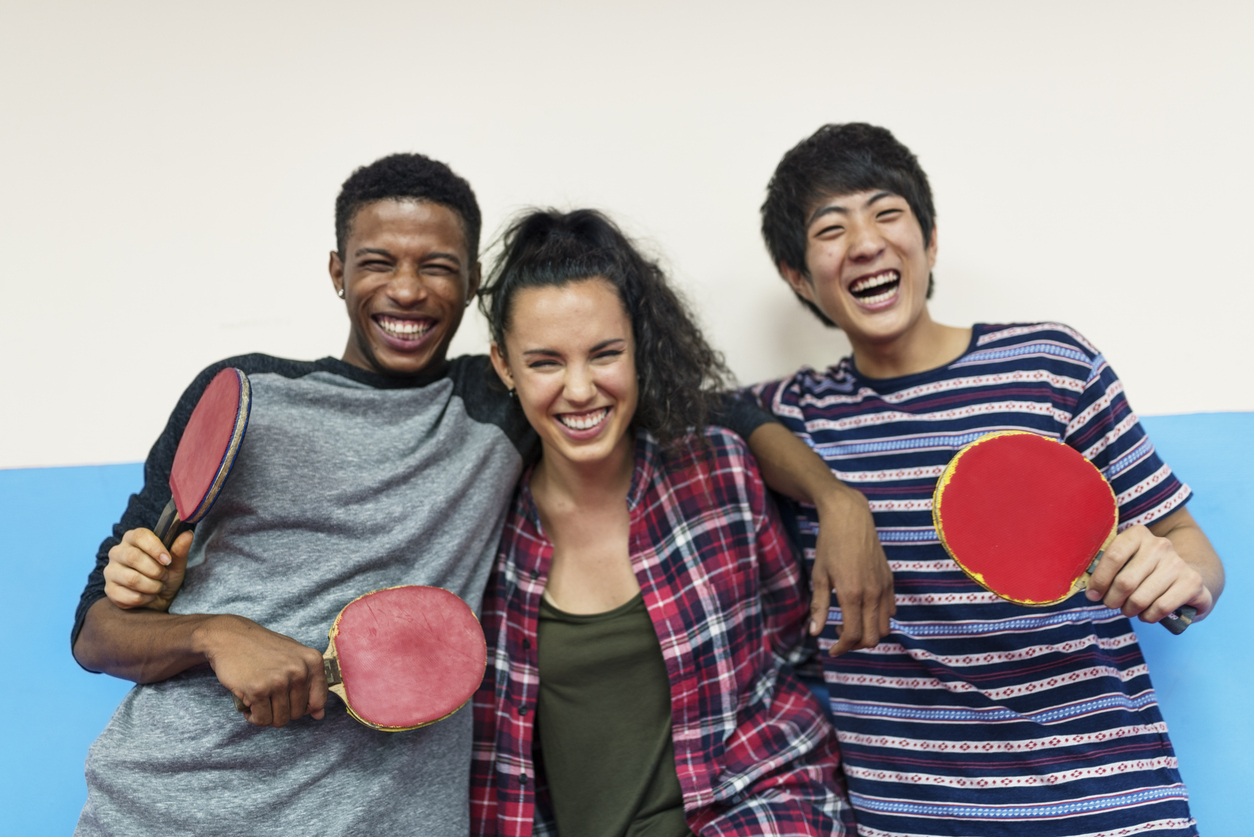 Teens with ping pong paddles