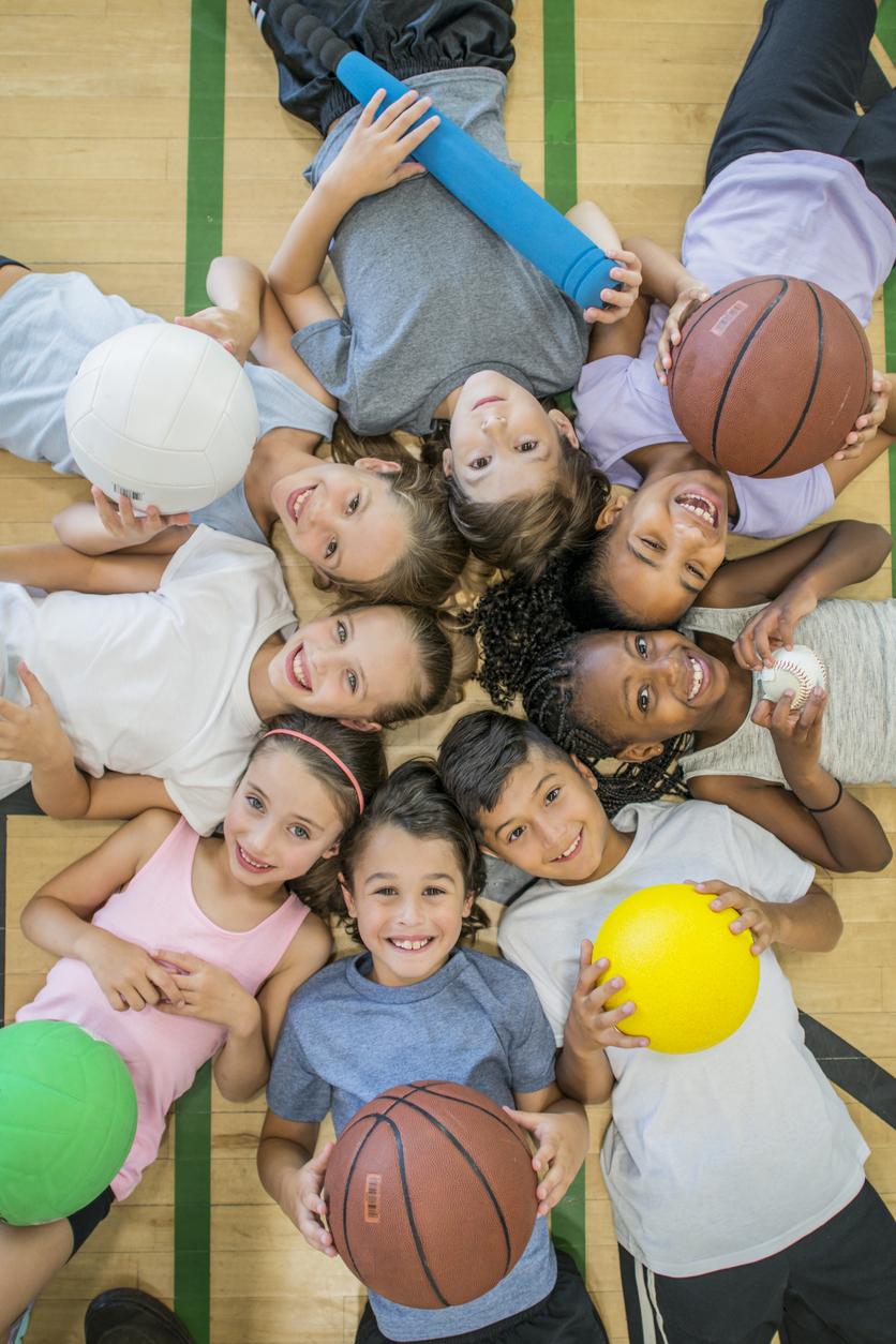 kids in a circle with assorted balls